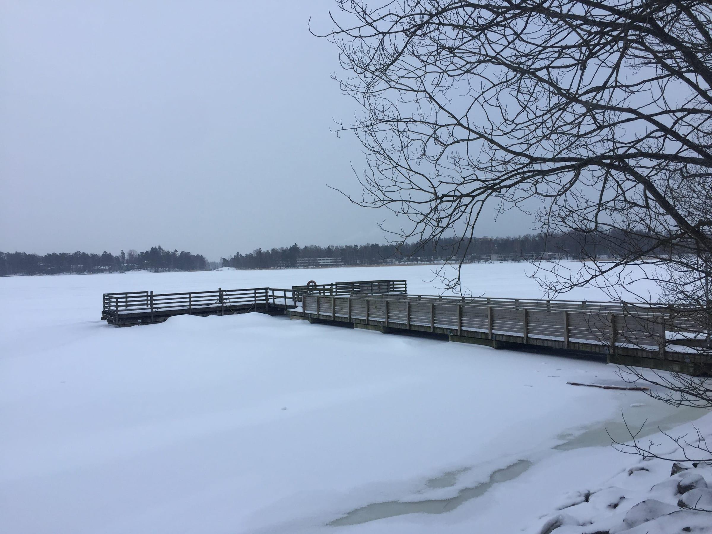 Frozen lake pier in winter