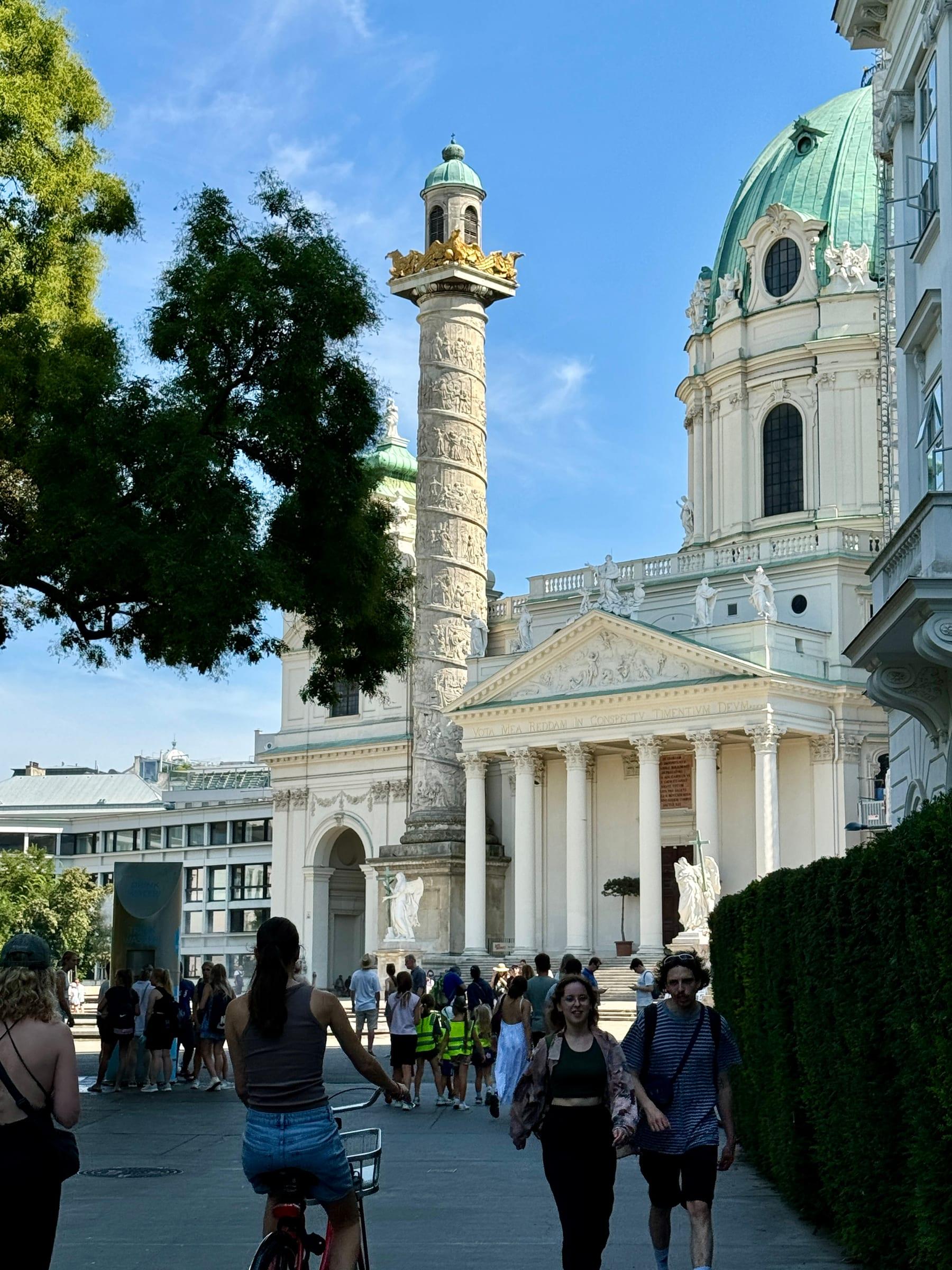 Karlskirche and column with tourists in Vienna